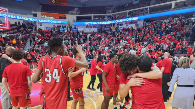Reading players celebrate winning the 2023 PIAA Class 6A basketball state championship.